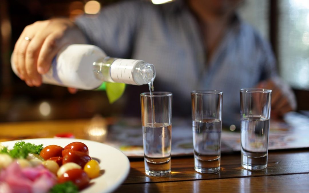 A man pouring vodka in a pub