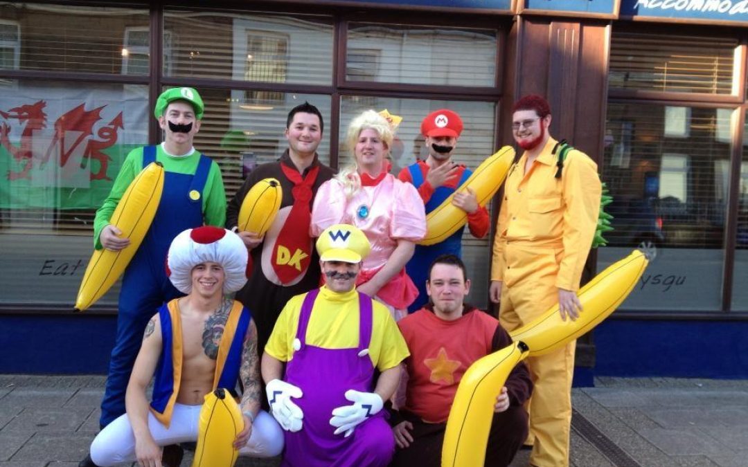 A group of people in funny costumes celebrating bachelor weekend
