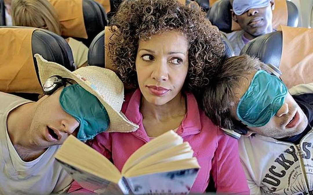 People sleeping and reading books on the plane