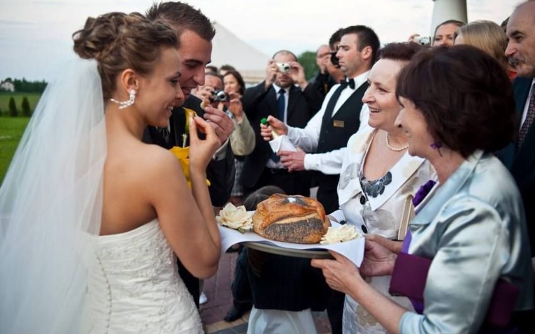 A couple eating bread and salt durring wedding ceremony
