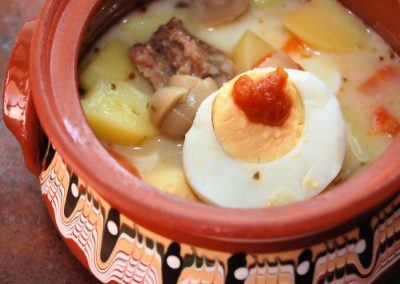 An earthen bowl with a traditional polish sour rye soup